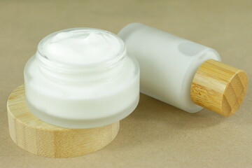 Moisturizing cream in eco-friendly bamboo jar. Natural organic cosmetic packaging design. Hand skin care concept.