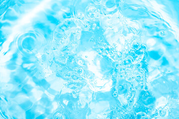 Pool, hot tub water background. Ripples on bright blue transparent water in swimming pool with light reflection. Top view