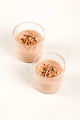 Vegan creamy buckwheat pudding in a glass on a light background