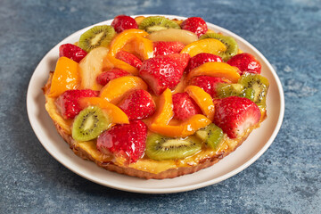 Delicious fresh seasonal fruit tart and cream.