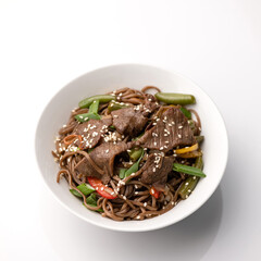 Rice with meat and sesame seeds. Food plate isolated on white background, Top view. Appetizer dish from restaraunt menu. Exquisite served dish.