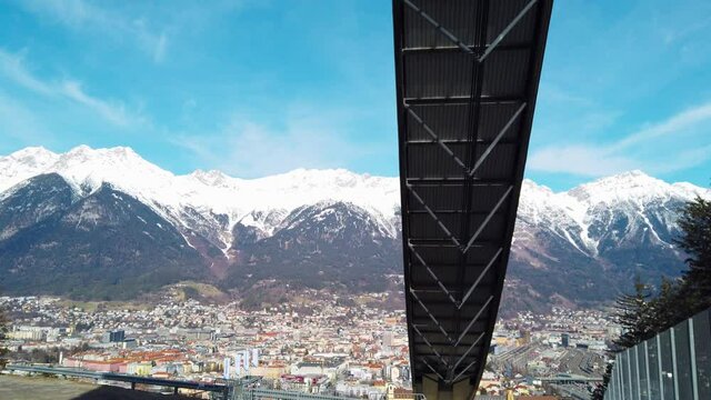 The stadium of the ski jumping hill tower and the track. In the background the city of Innsbruck