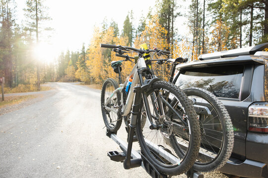 SUV With Bikes On Rack In Forest