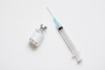 Medical vial of injectable medicine and hypodermic needle isolated on a white background