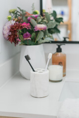 Fluffy toothbrushes in bathroom setting, modern bathroom