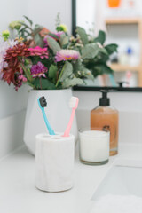 Fluffy toothbrushes in bathroom setting, modern bathroom