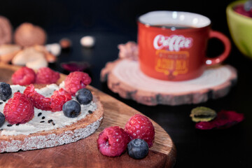 close-up of blueberry and raspberry for breakfast with toast and coffee