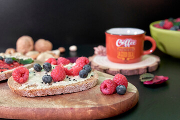 close-up of blueberry and raspberry for breakfast with toast and coffee