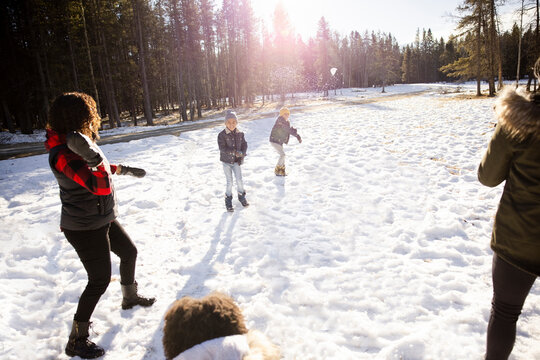 Family Playing In Snow