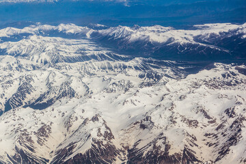 Fototapeta premium Aerial view of snow covered Tian Shan mountains in Kyrgyzstan