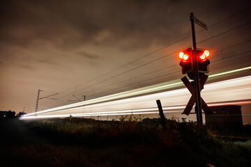 Busy railroad crossing at night in the west of Germany.