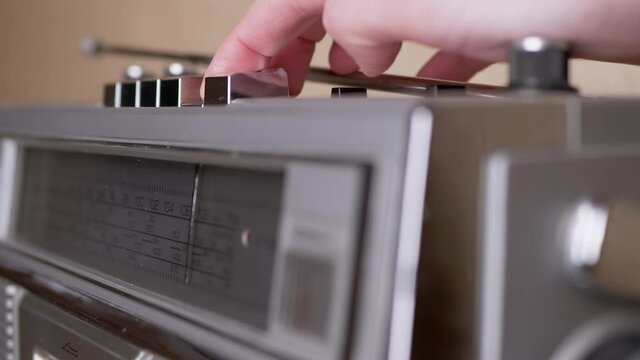 Female Hand Presses Play Button on Retro Tape Recorder with Cassette. Zoom