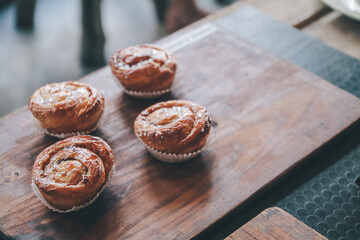 Kouign amann: Croissants on wooden background in restaurant, breakfast pastries, french pastries.