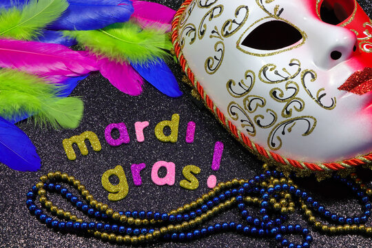 Mardi Gras Text And Beads With Mask And Feathers