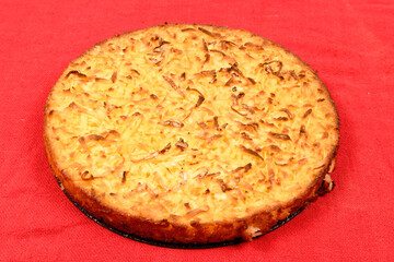 Whole cassava cake on red fabric background