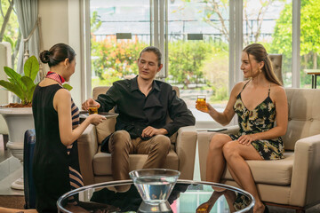 traveller couple being served with welcome drink from asian hotel reception