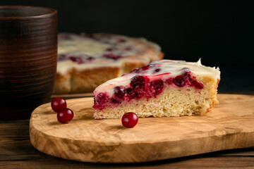 Homemade cake with cranberries and sour cream. Piece of pie close up