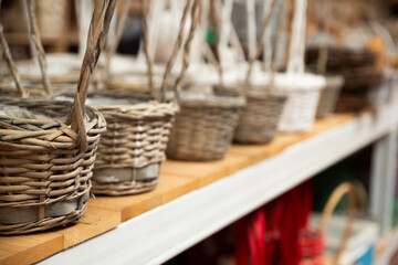 Variety of wicker baskets on shelves in home decor store