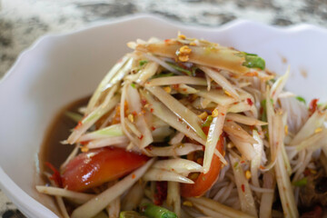 Spicy green papaya salad serve