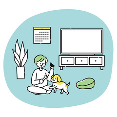 リビングで犬と一緒に遊ぶ男性