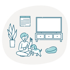 リビングで犬と一緒に遊ぶ男性