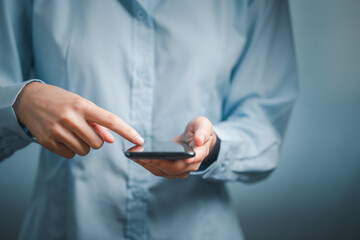 Close up, woman hand using black smartphone.v
