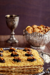 Matzo cake with silver kiddush cup and walnuts.