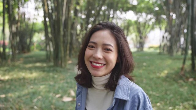 Pov following view of pretty asian girlfriend running in the bamboo forest smile at camera lovely young Chinese woman relax walking in the nature causal lifestyle 4k slow motion
