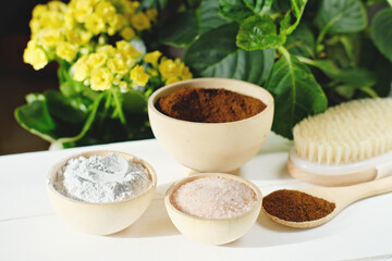 ingredients for homemade exfoliating body scrub. spring skin renew and cellulite treatment. hand made organic cosmetics. coffee, pink salt and clay powder with massage brush