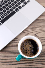 Obraz na płótnie Canvas Coffee next to laptop