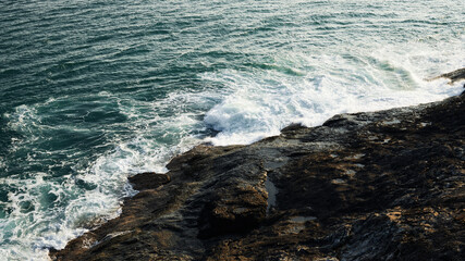 Green sea waves with rocks.