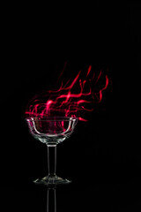 Champagne coupe. Light painting (red particles).