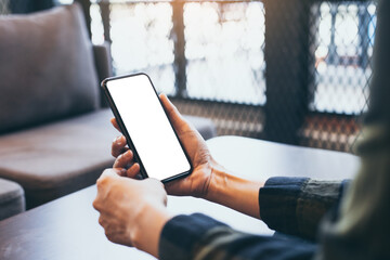 cell phone blank white screen mockup.woman hand holding texting using mobile on desk at office.background empty space for advertise.work people contact marketing business,technology