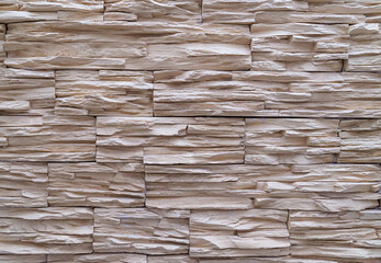 the texture of light brown masonry on the wall. stone brick building surface background