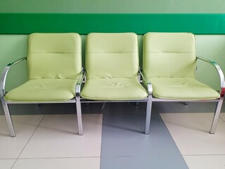 Chairs in the hallway for waiting . Empty chairs in the reception area.