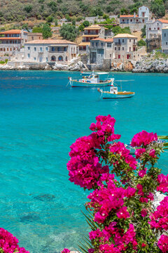 Limeni village with the famous  stone buildings a blooming bougainvillea, and turquoise waters in Mani, South Peloponnese , Greece.