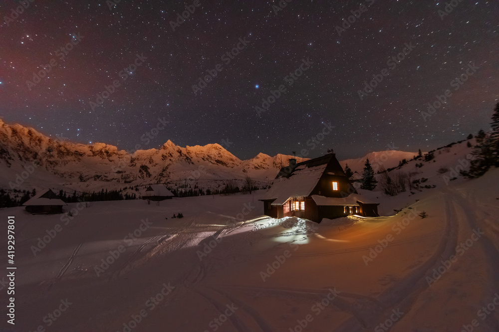 Wall mural night winter landscapes in the high tatras, with mountain houses on a background of snow-capped moun