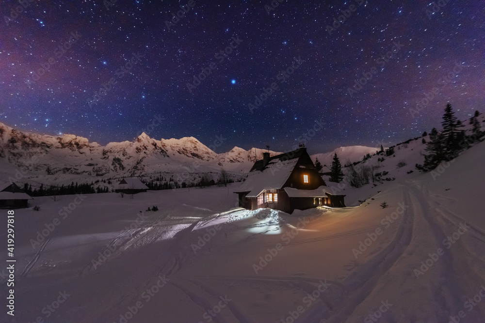 Wall mural night winter landscapes in the high tatras, with mountain houses on a background of snow-capped moun