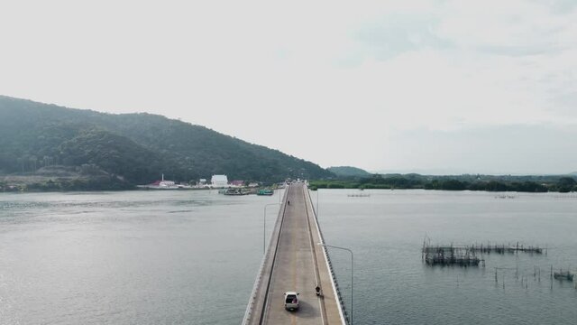 Aerial view of a bridge connecting island overlooking road traffic. Taksin Maharat Bridge (Laem Singha Bridge)