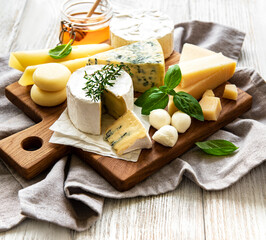 Various types of cheese  on a white wooden  background