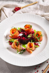 Cured Salmon Gravlax with Beet and Berries. Salted fish fillet with beetroot and dill in white plate on table. Gourmet, swedish, scandinavian seafood concept.