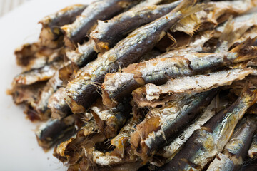 Fototapeta premium Healthy food. Delicious sardines baked in oven served on white plate..