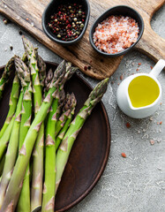 Bunch of raw asparagus stems with different spices