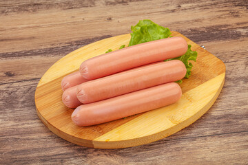 Tasty meat sausages over board