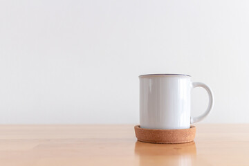 White cup of hot coffee mug on wooden table with isolate white background.