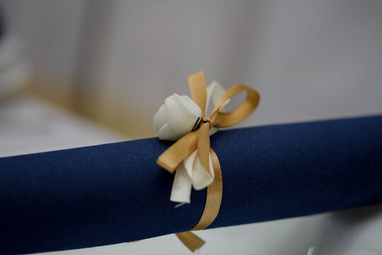 Closeup Shot Of Rolled Blue Table Napkin With Ribbon