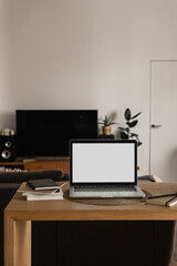 Blank screen laptop computer. Home office desk table workspace. Modern nordic interior design. Copy space mockup template. Front view work at home, pandemic quarantine self-isolation business concept.