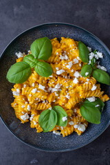 Creamy roasted pumpkin penne pasta on a table