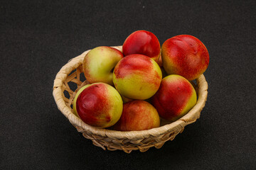 Sweet small nectarines in the basket