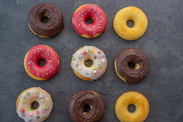 Donuts pattern. Top view of assorted glazed donuts